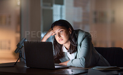 Buy stock photo Cropped shot of an attractive young businesswoman looking bored while working late at her company offices