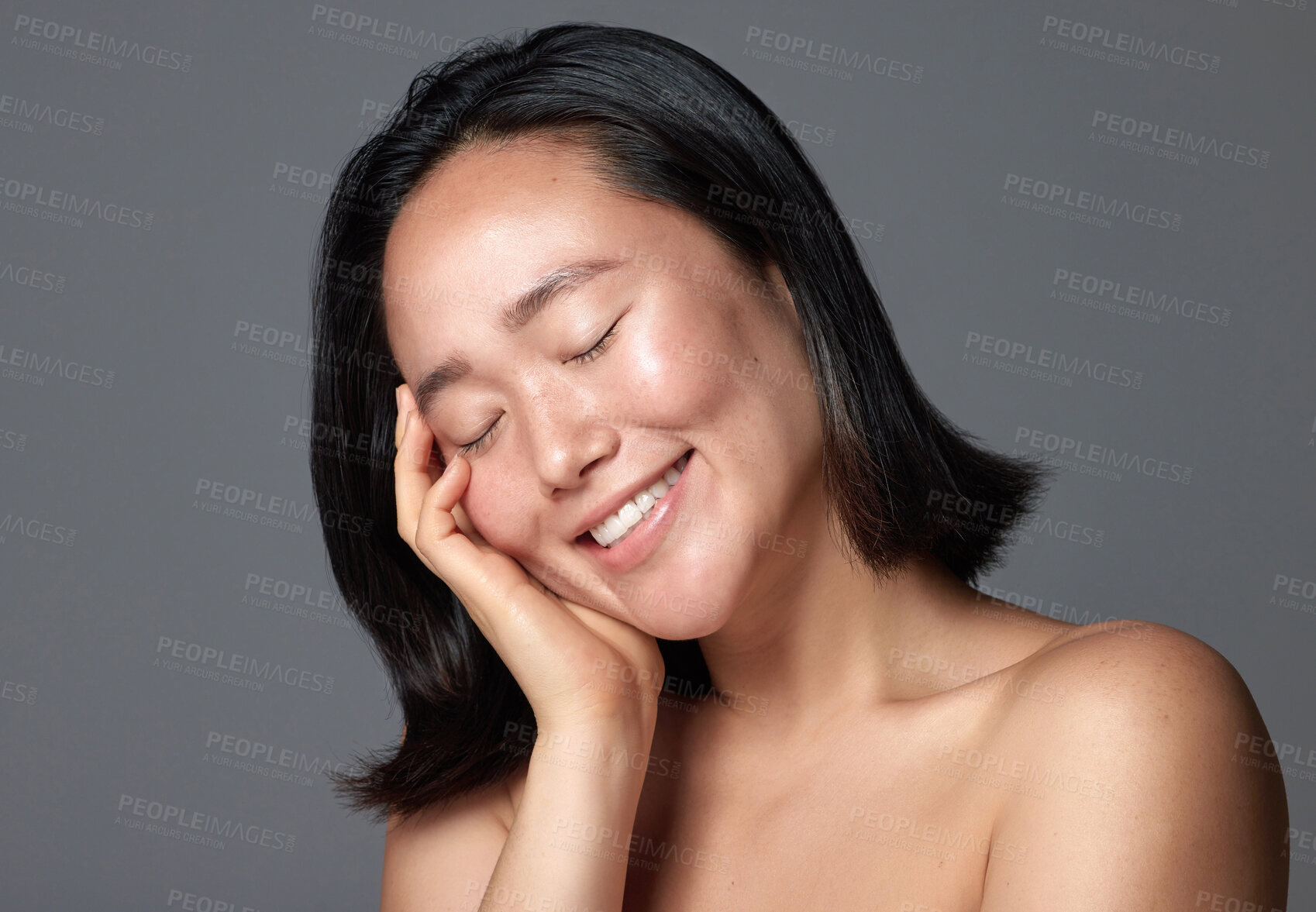 Buy stock photo Studio shot of a beautiful young woman posing against a grey background