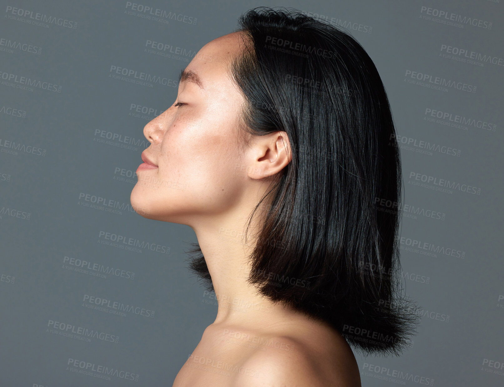 Buy stock photo Studio shot of a beautiful young woman posing against a grey background