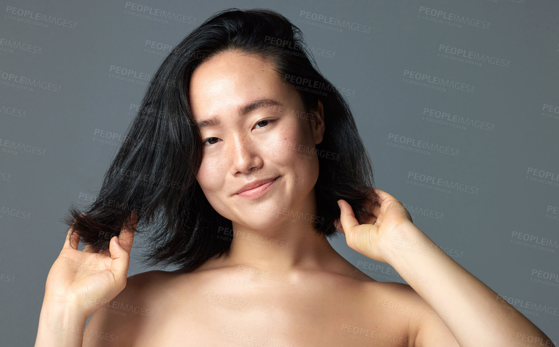 Buy stock photo Studio shot of a beautiful young woman posing against a grey background