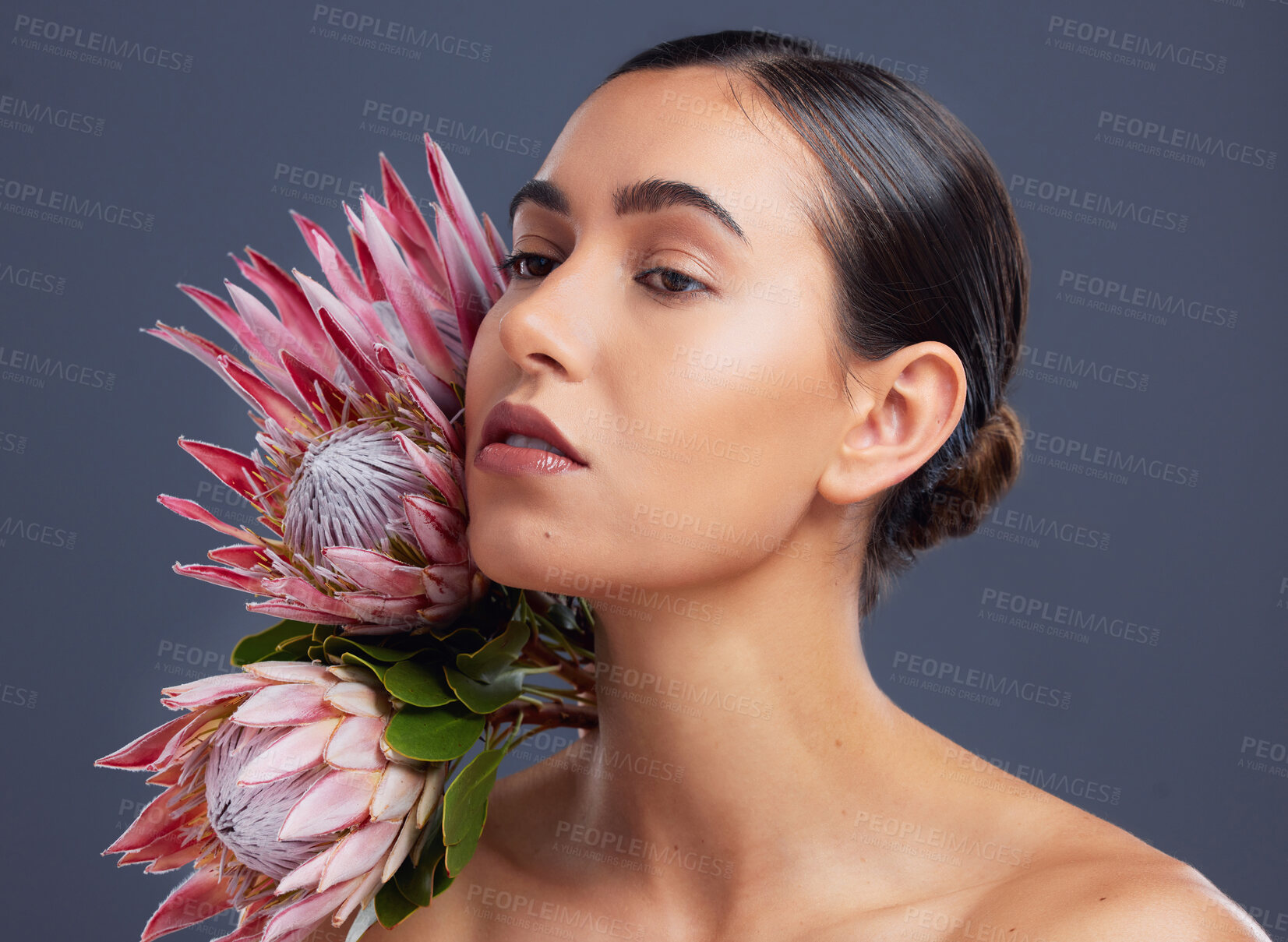 Buy stock photo Thinking, woman and beauty with flower in studio for natural skincare, hydration and facial glow. Vision, person and protea for organic cosmetics, healthy skin and floral treatment on gray background
