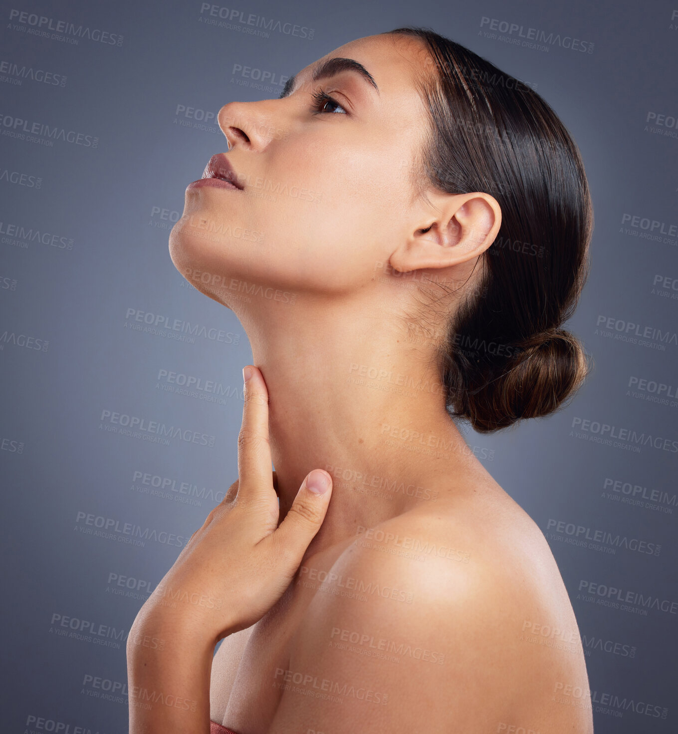 Buy stock photo Studio shot of a beautiful young woman posing against a grey background