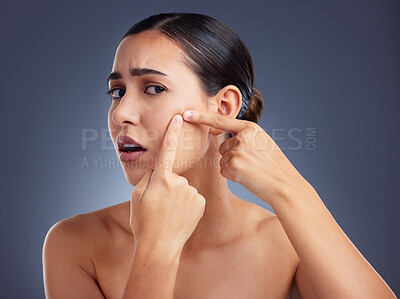 Buy stock photo Shot of a woman squeezing a pimple on her face