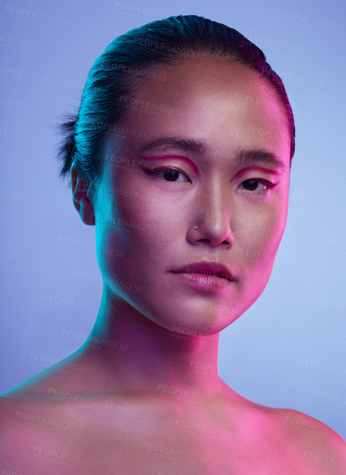 Buy stock photo Cropped shot of an attractive young woman posing in studio against a purple background