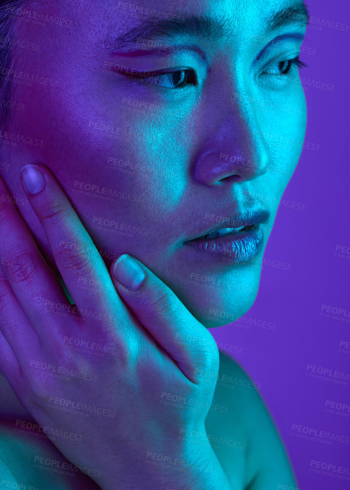 Buy stock photo Cropped shot of an attractive young woman posing in studio against a purple background