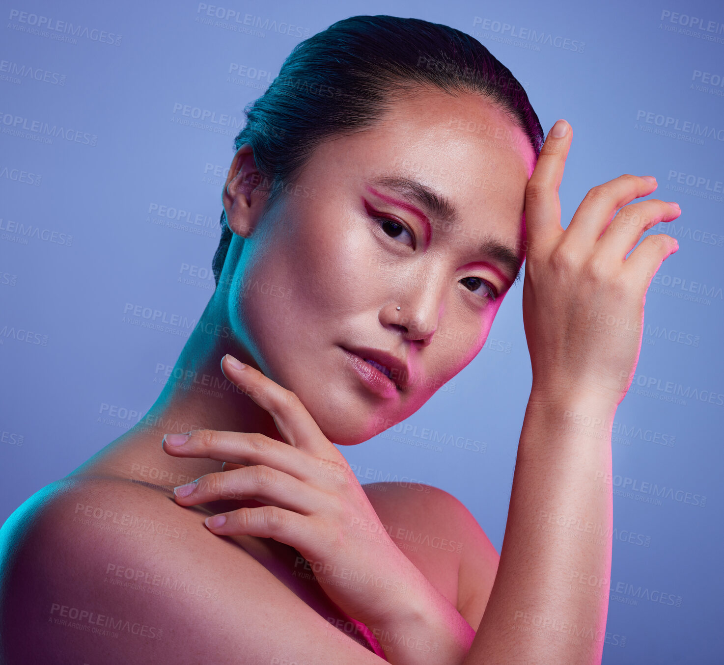 Buy stock photo Cropped shot of an attractive young woman posing in studio against a purple background