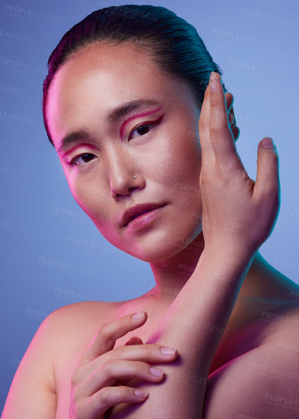 Buy stock photo Cropped shot of an attractive young woman posing in studio against a purple background