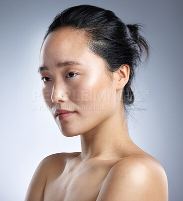 Buy stock photo Shot of a young woman standing against a grey background