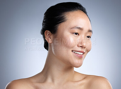 Buy stock photo Shot of a young woman standing against a grey background