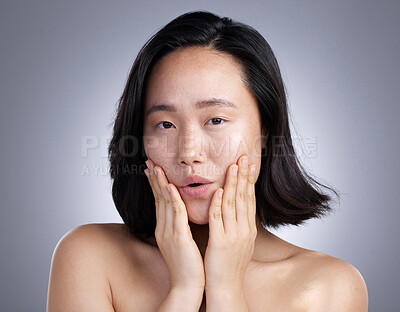 Buy stock photo Shot of a young woman standing against a grey background