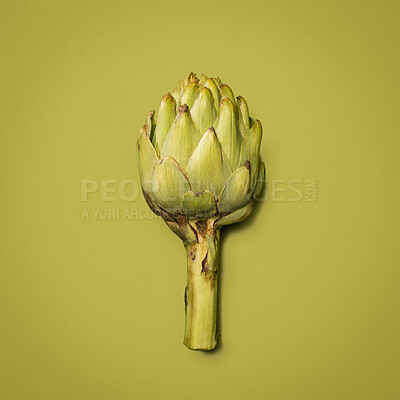 Buy stock photo Crop, artichoke and healthy in studio, vegetable and space for food, nutrition and diet with vitamin. Green background, raw and organic for dinner of salad, meal and wellness of  flower in mockup