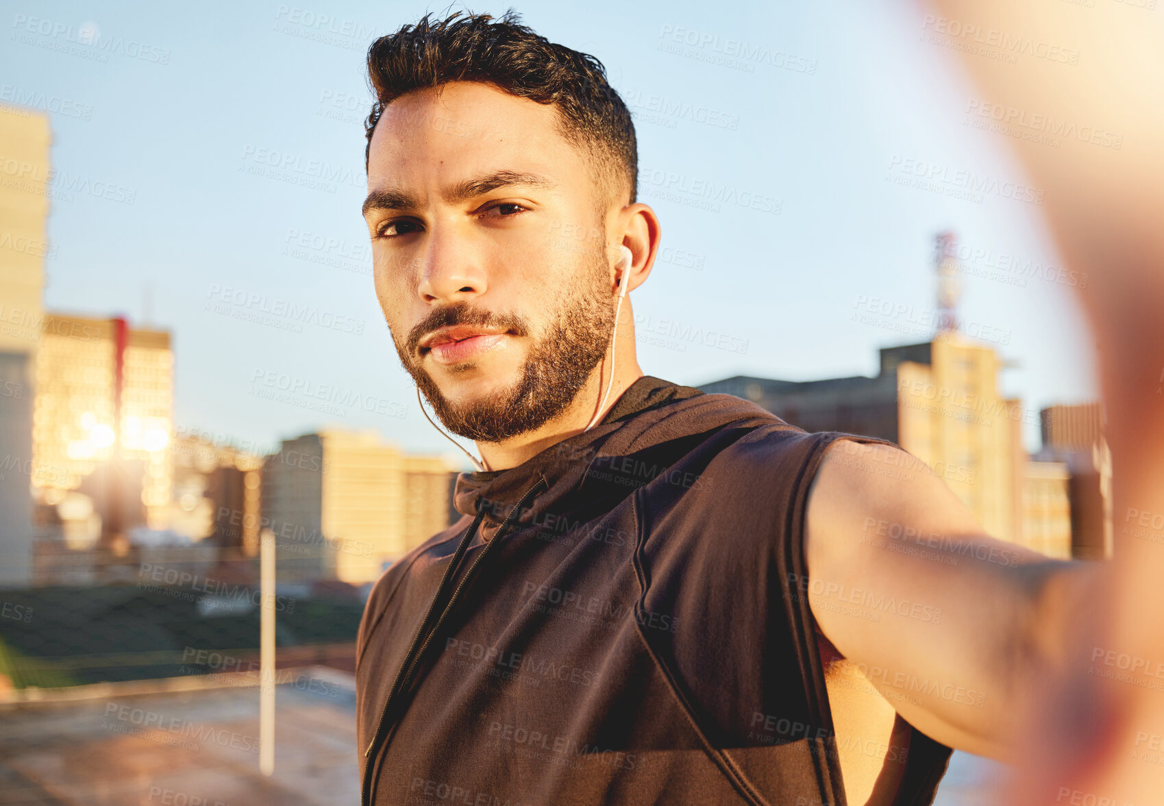 Buy stock photo Shot of a young man taking a selfie while out for a workout