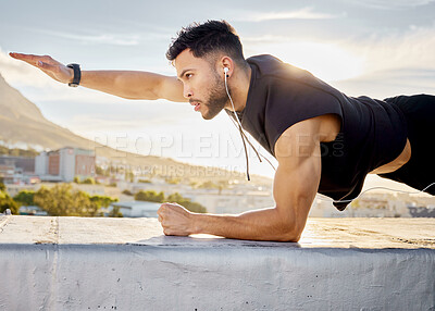 Buy stock photo Shot of a man doing a single-arm plank while on a rooftop