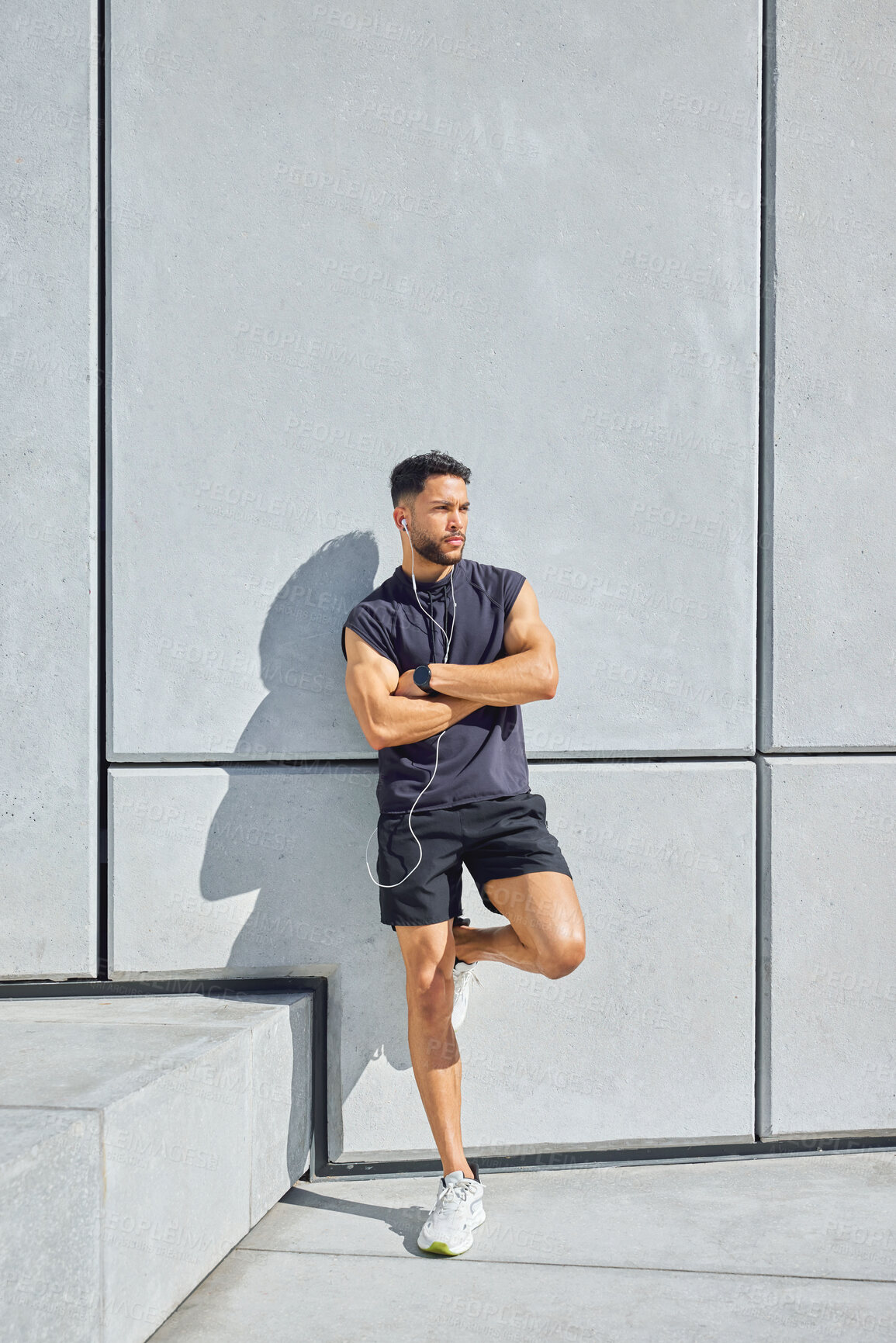 Buy stock photo Athlete, music or thinking with arms crossed outdoor for exercise break, wellness podcast or health. Earphones, man or thoughtful at wall for runner reflection, streaming playlist or relax with space