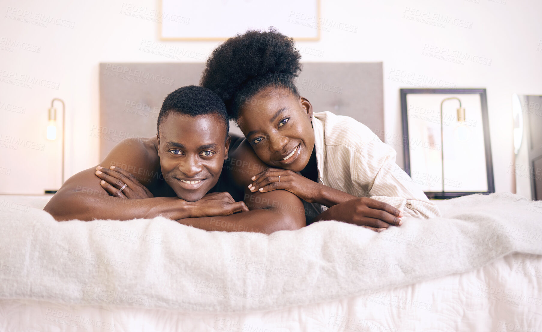 Buy stock photo Shot of a young couple relaxing together at home