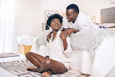 Buy stock photo Shot of a young couple relaxing together at home