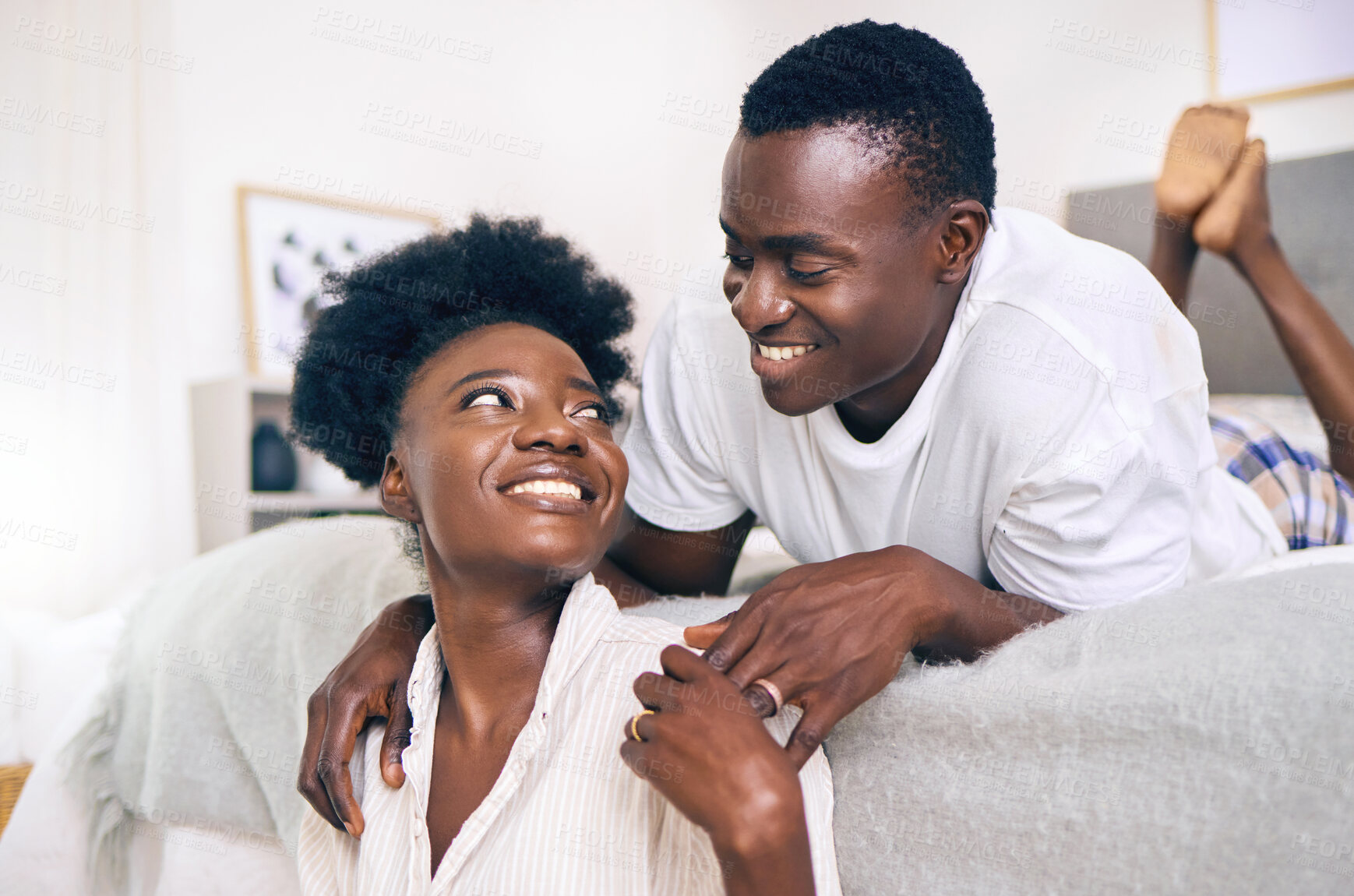 Buy stock photo Shot of a young couple relaxing together at home