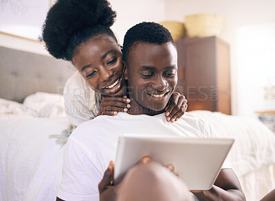 Buy stock photo Shot of a young couple using a digital tablet together at home