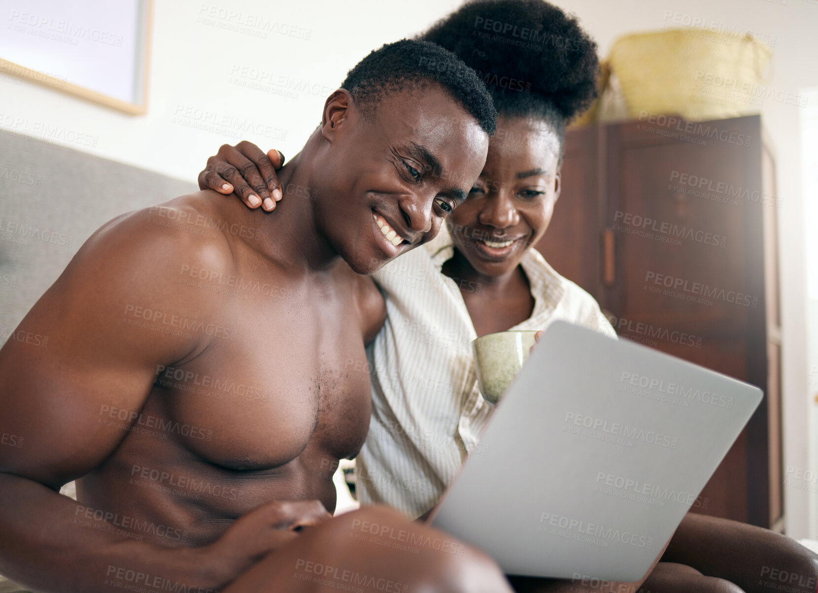 Buy stock photo Shot of a young couple using a laptop together at home