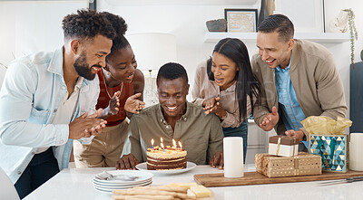 Buy stock photo Shot of a young man celebrating his birthday with friends at home