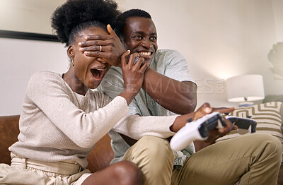 Buy stock photo Shot of a young couple playing video games at home