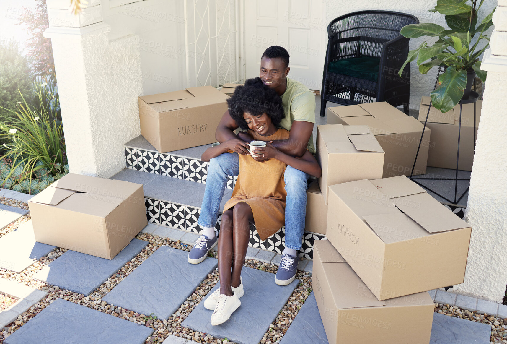 Buy stock photo Shot of a young couple drinking coffee while moving into their new house