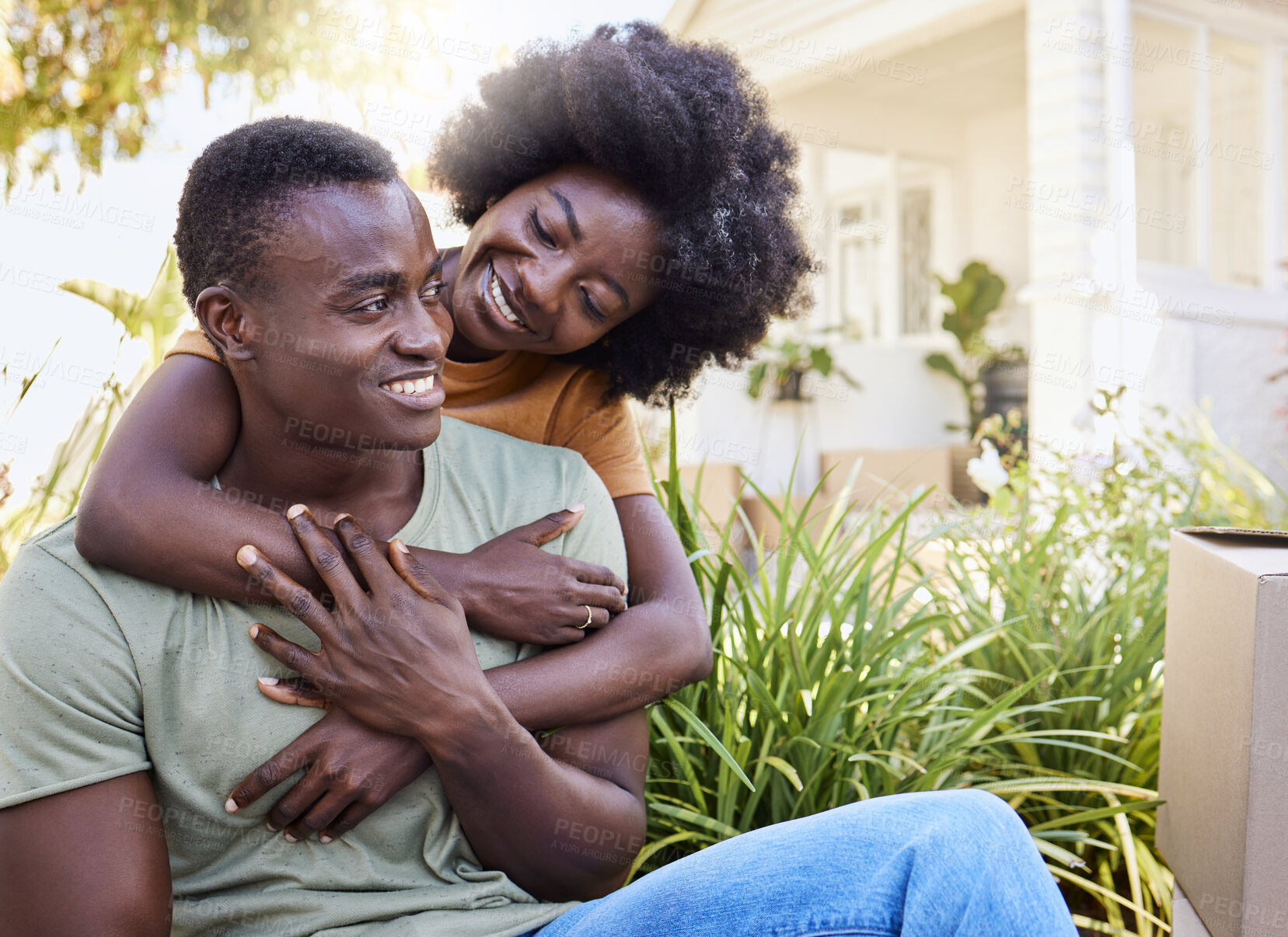 Buy stock photo Shot of a young couple moving into their new house