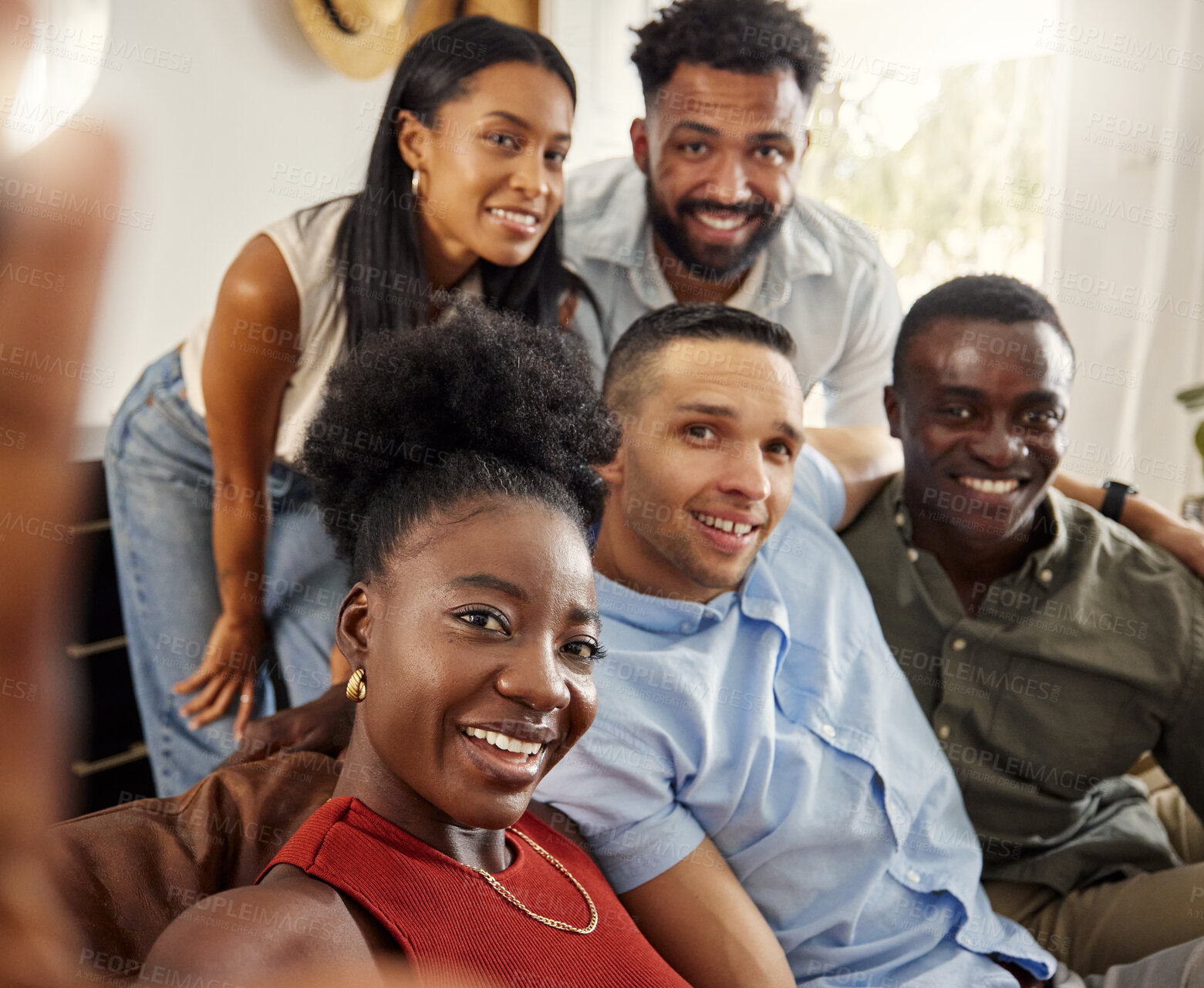 Buy stock photo Shot of a woman taking a selfie with a group of friends at home