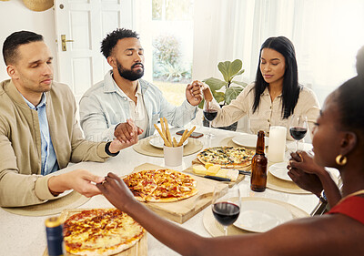 Buy stock photo Shot of a group of friends saying grace before eating a meal together
