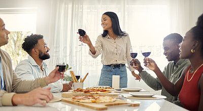 Buy stock photo Shot of a group of people sharing a toast around the dining table in a house