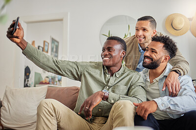 Buy stock photo Shot of a man taking a selfie with his two friends at home