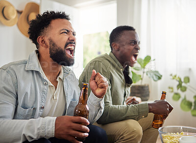 Buy stock photo Shot of two male friends looking cheerful while drinking beers and sitting together