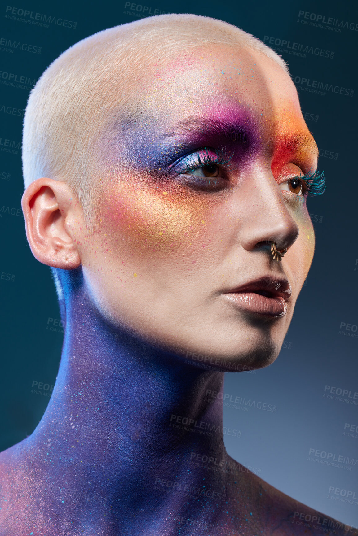 Buy stock photo Studio shot of a young woman posing with multi-coloured paint on her face