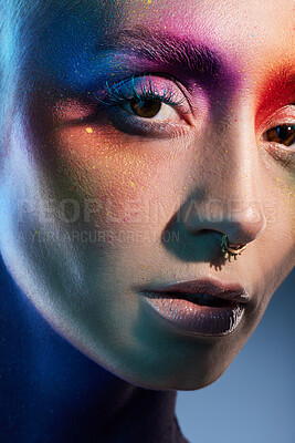 Buy stock photo Studio shot of a young woman posing with multi-coloured paint on her face