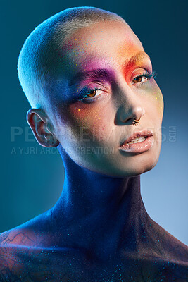 Buy stock photo Studio shot of a young woman posing with multi-coloured paint on her face