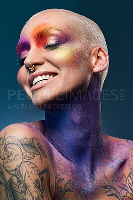 Buy stock photo Studio shot of a young woman posing with multi-coloured paint on her face