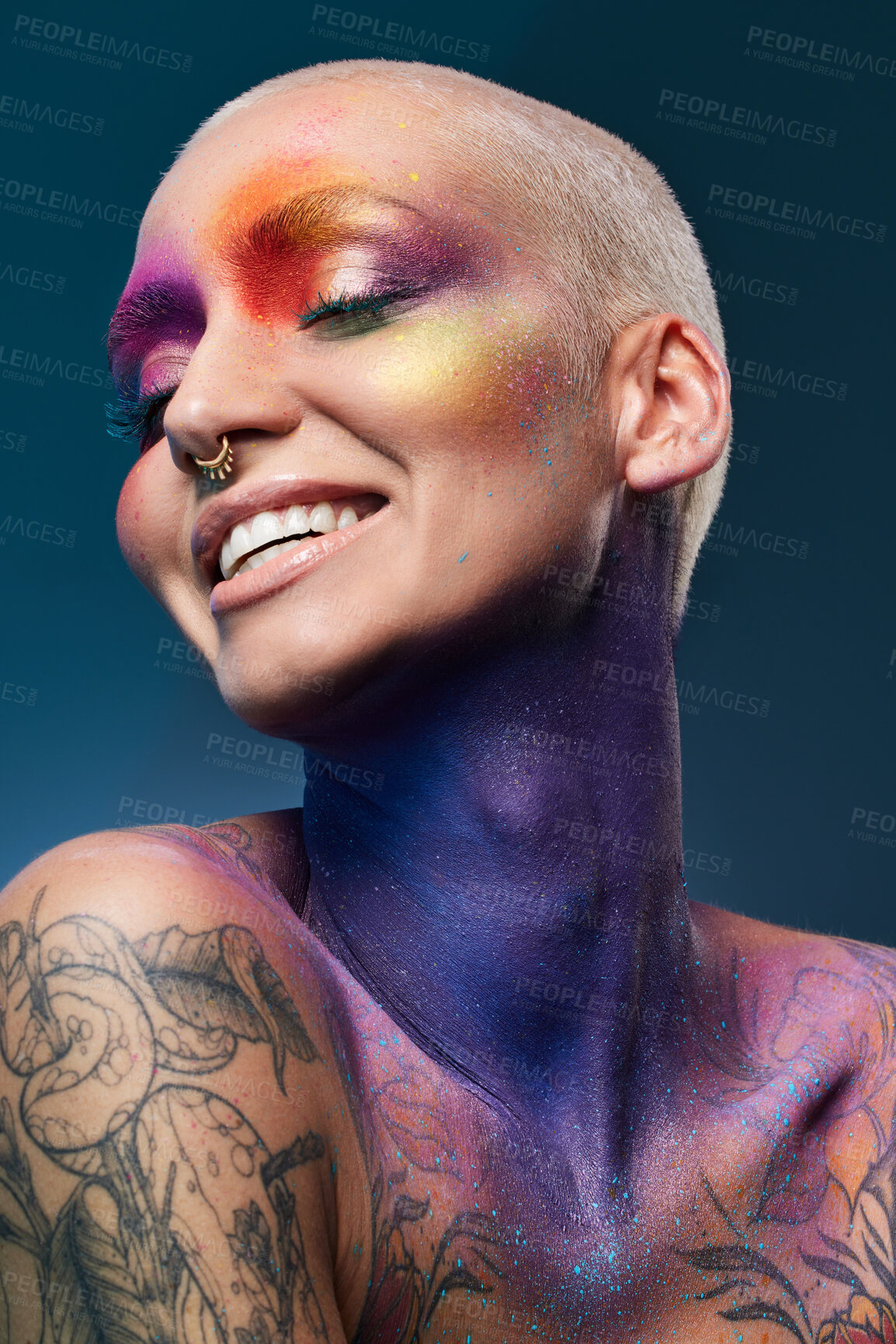 Buy stock photo Studio shot of a young woman posing with multi-coloured paint on her face