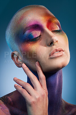 Buy stock photo Studio shot of a young woman posing with multi-coloured paint on her face