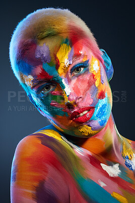 Buy stock photo Studio shot of a young woman posing with multi-coloured paint on her face