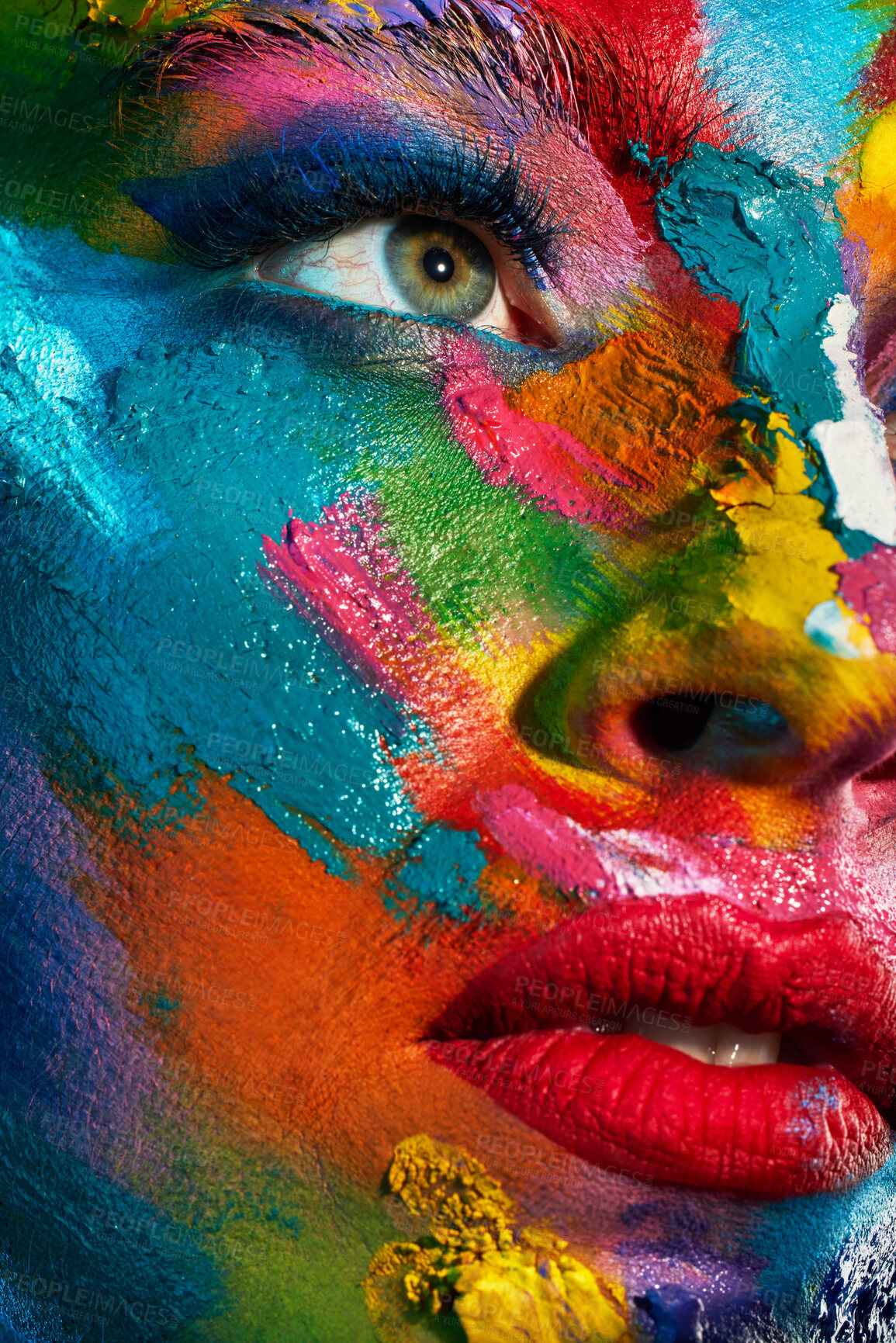 Buy stock photo Studio shot of a young woman posing with multi-coloured paint on her face