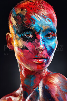 Buy stock photo Shot of an attractive young woman posing alone in the studio with paint on her face