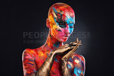 Buy stock photo Shot of an attractive young woman posing alone in the studio with paint on her face and body