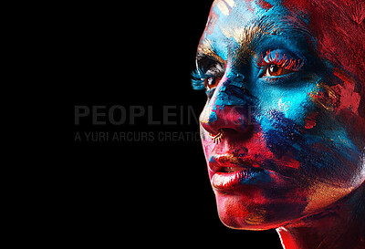 Buy stock photo Shot of an attractive young woman posing alone in the studio with paint on her face