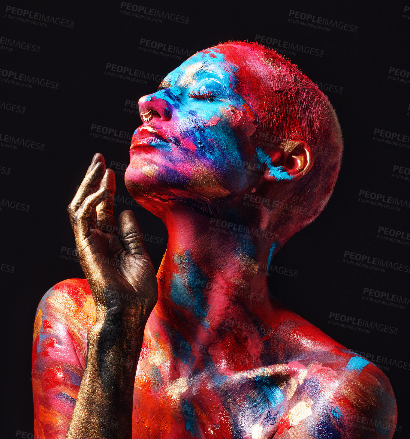 Buy stock photo Shot of an attractive young woman posing alone in the studio with paint on her face and body