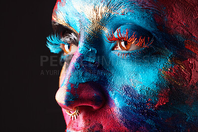 Buy stock photo Cropped shot of an unrecognisable woman posing alone in the studio with paint on her face