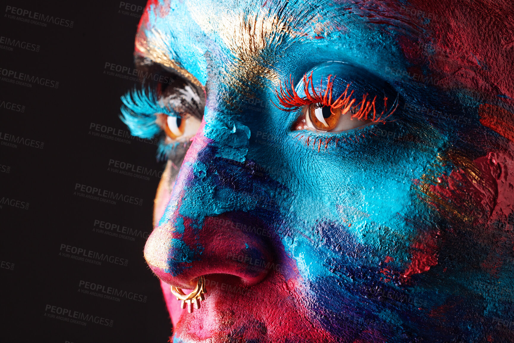 Buy stock photo Cropped shot of an unrecognisable woman posing alone in the studio with paint on her face