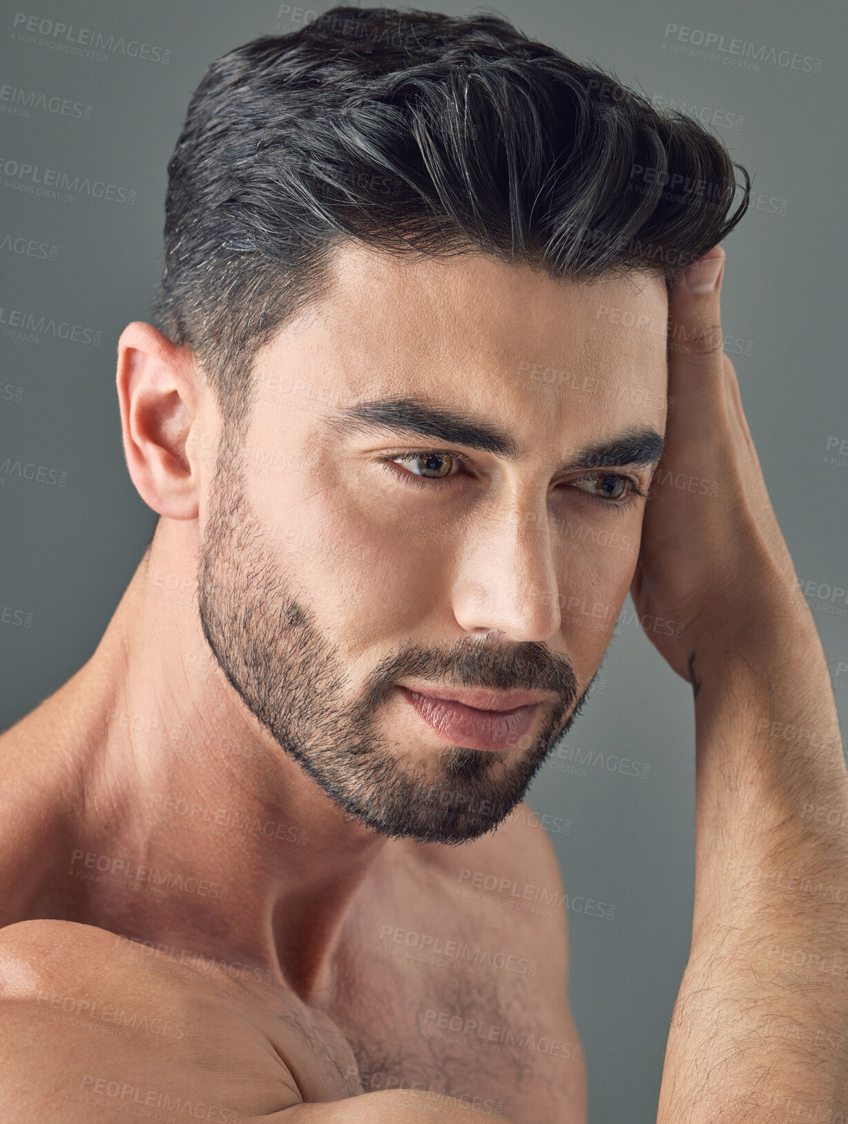 Buy stock photo Skincare, touch or man in studio with thinking, shine or glowing in facial care. Reflection, wellness or person with smooth skin, dermatology solution or natural cosmetics on gray background.