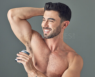 Buy stock photo Shot of a man applying deodorant to his underarms