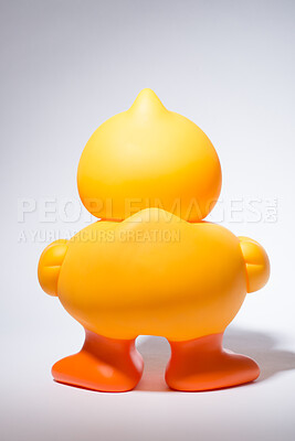 Buy stock photo Rubber, duck and back in studio for bath, playing and children entertainment with fun squeaky sound. Plastic bird, toy and white background for kids, pool and water with childhood games or activity