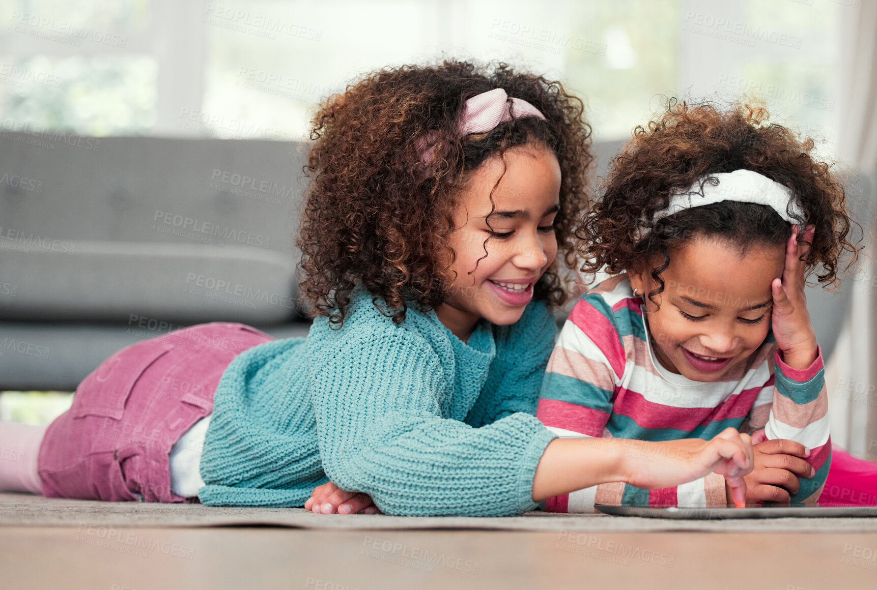 Buy stock photo Sisters on floor, house and relax with tablet, typing and playing online games in living room. Kids, apartment and girls with tech, funny or social media with digital app for fun and scroll for ebook